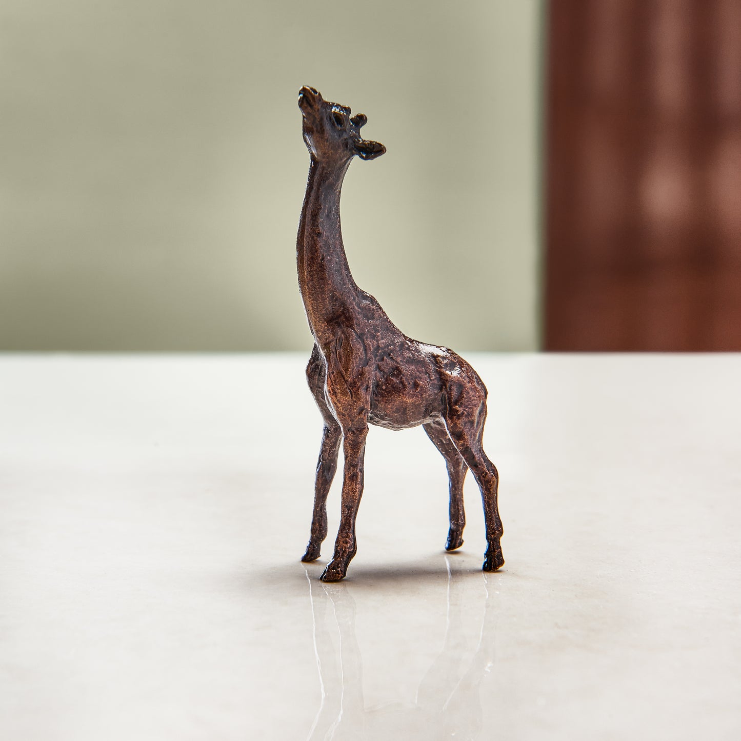 Miniature bronze figurine of a giraffe. Give as a bronze anniversary gift or thoughtful birthday gift.
