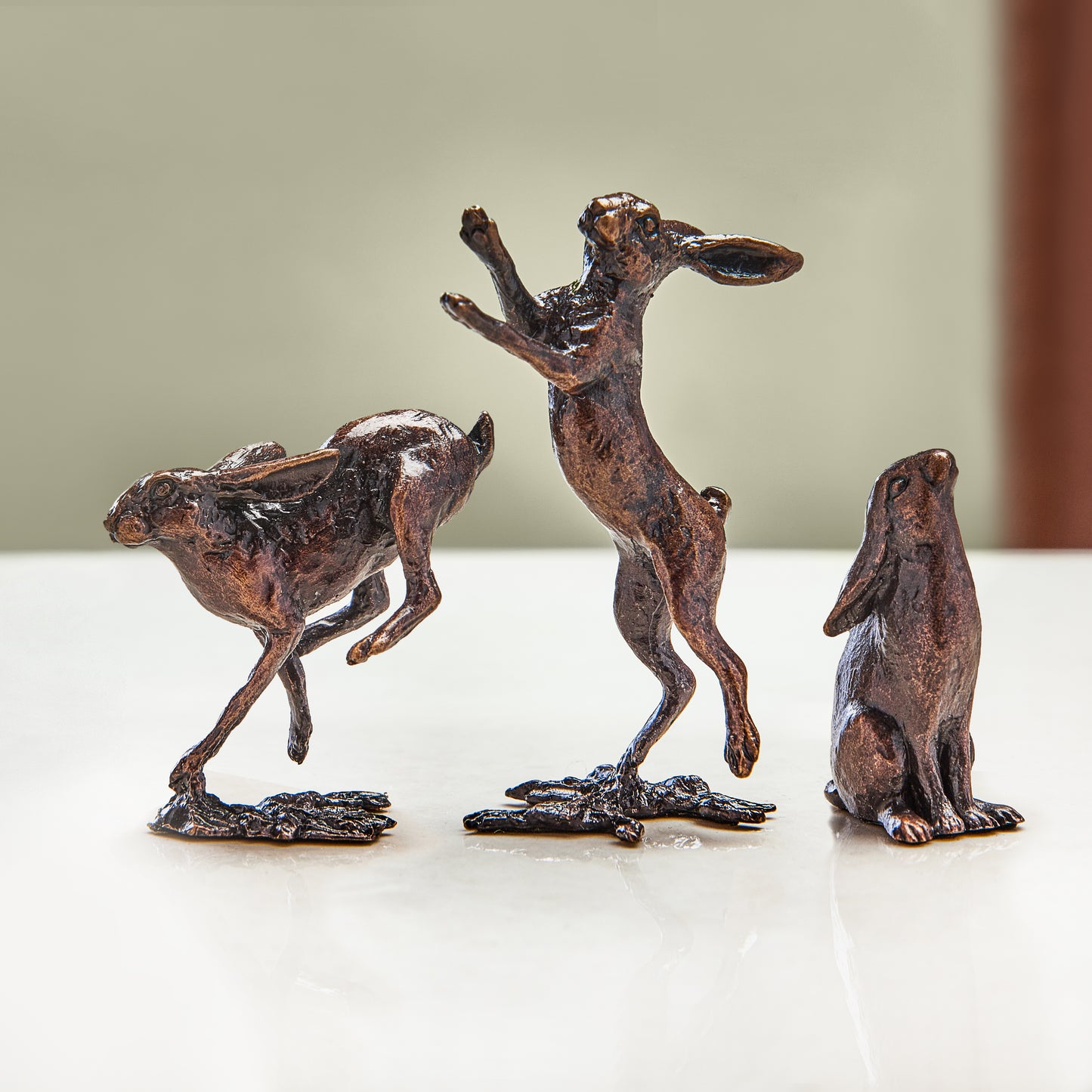 Gift set of three miniature bronze hare figurines running, boxing and gazing at the moon, they’re ideal as a thoughtful birthday or bronze anniversary gift.