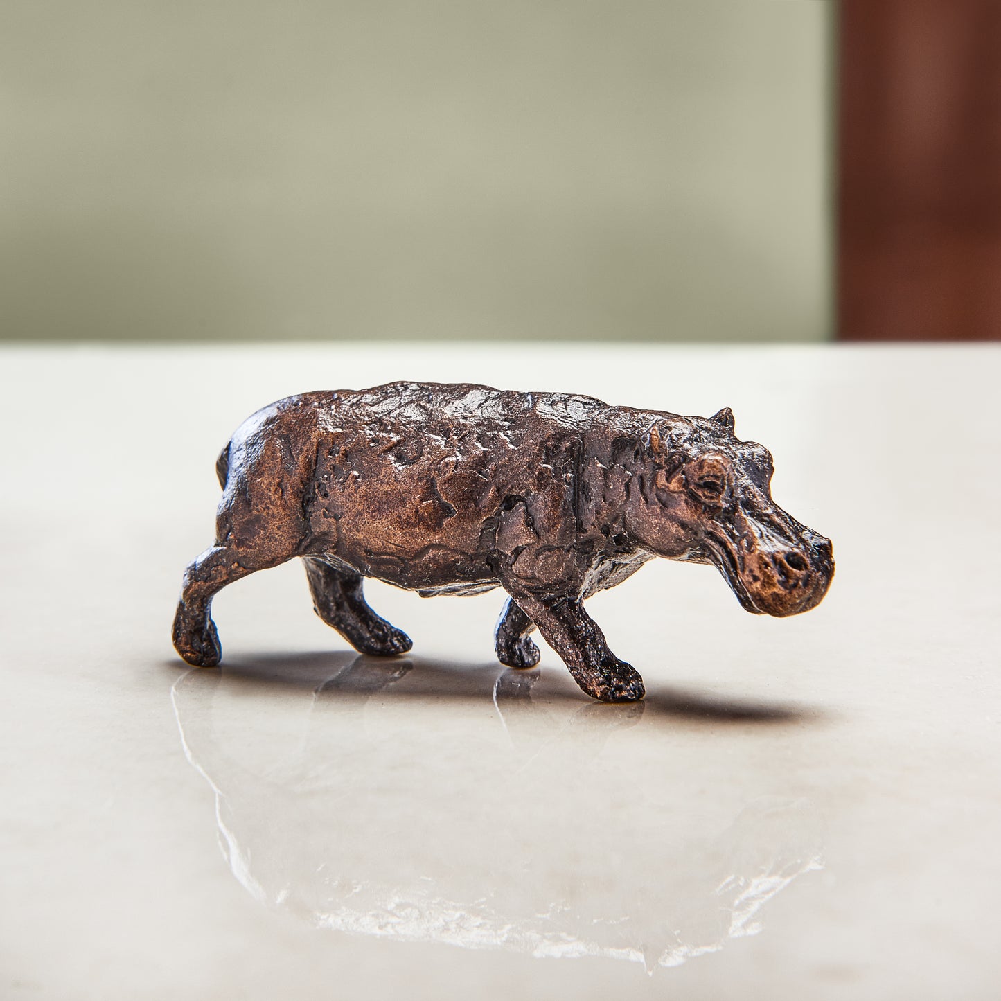 Miniature bronze figurine of a hippo. Give as a bronze anniversary gift or thoughtful birthday gift.