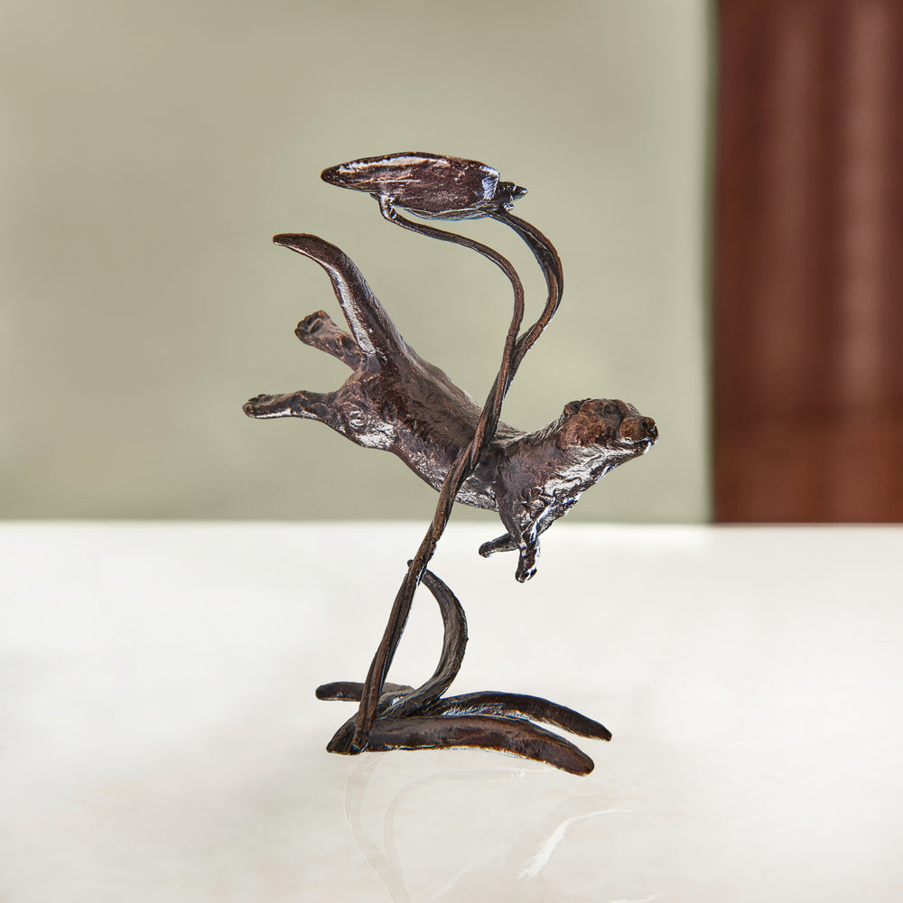 Miniature bronze figurine of an otter swimming under a lily pad. Gift for a bronze anniversary or special birthday. 