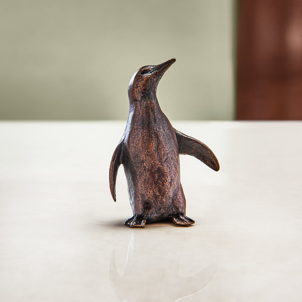 Miniature bronze figurine of a penguin. Give as a bronze anniversary gift or thoughtful birthday gift.