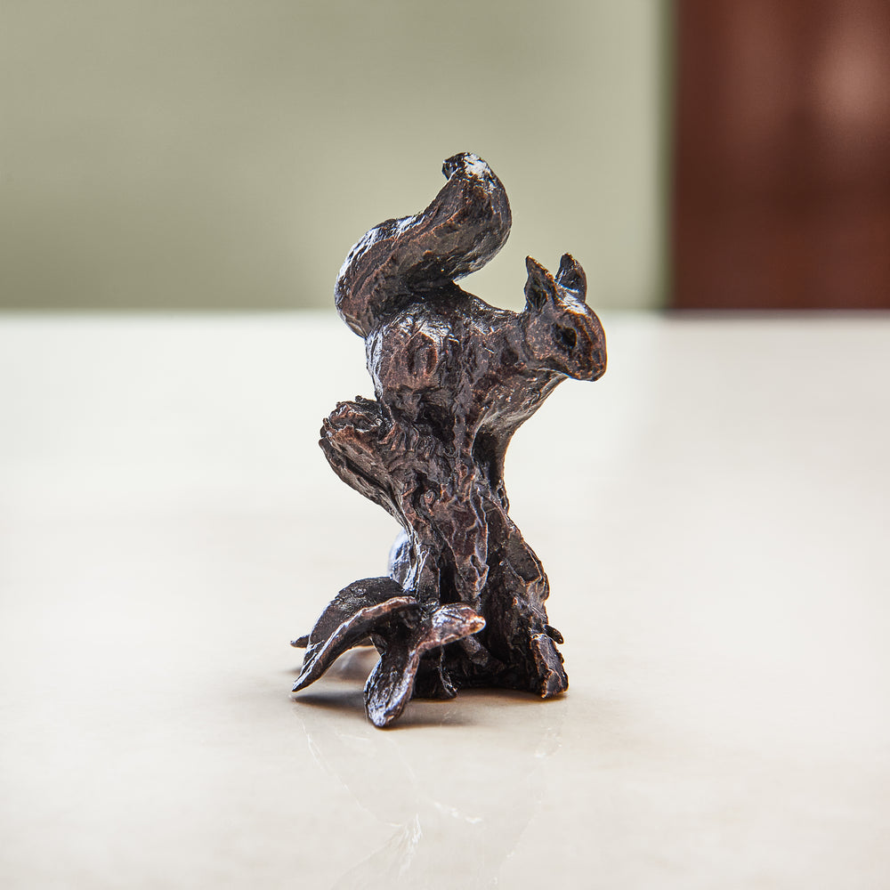 Miniature bronze figurine of a red squirrel, poised on a log. Give as a bronze anniversary gift or thoughtful birthday gift.