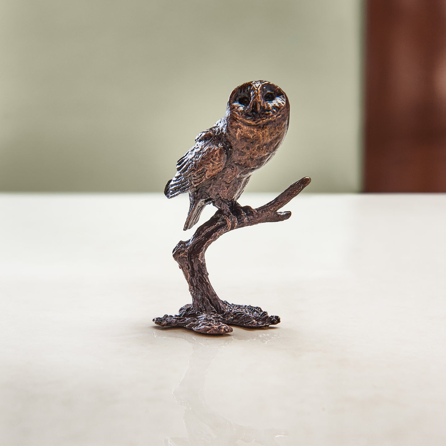 Miniature bronze figurine of a tawny owl perched on a branch. A perfect bronze anniversary gift.
