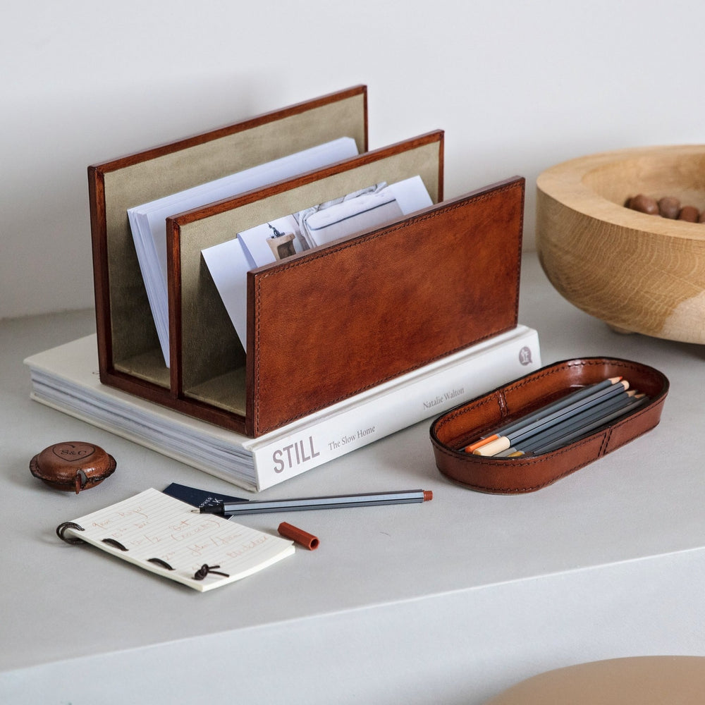 A thoughtful and unique gift for a new home or to celebrate retirement, this trio of letter rack, pen tray and personalised leather tape measure is classic, stylish and practical.  