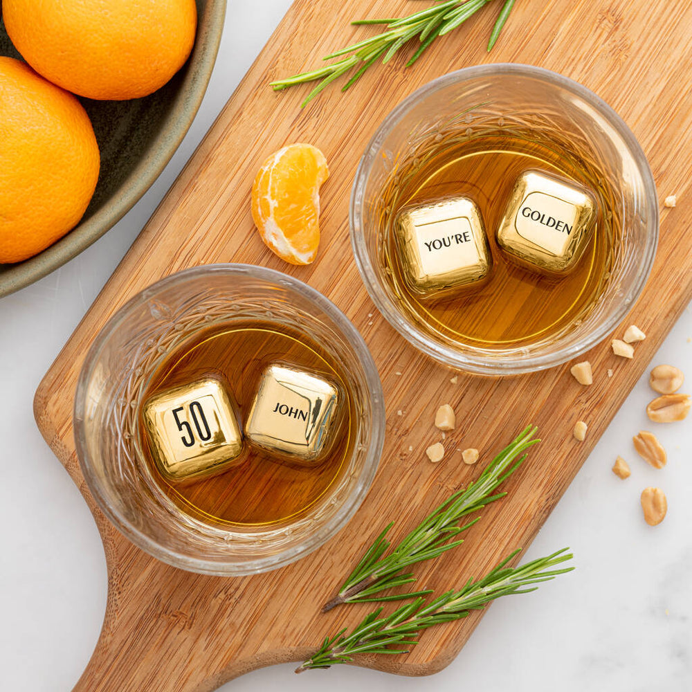 
                  
                    Set of four personalised gold finish stainless steel ice cubes. Add initials, names or dates to create a thoughtful golden wedding anniversary gift.
                  
                