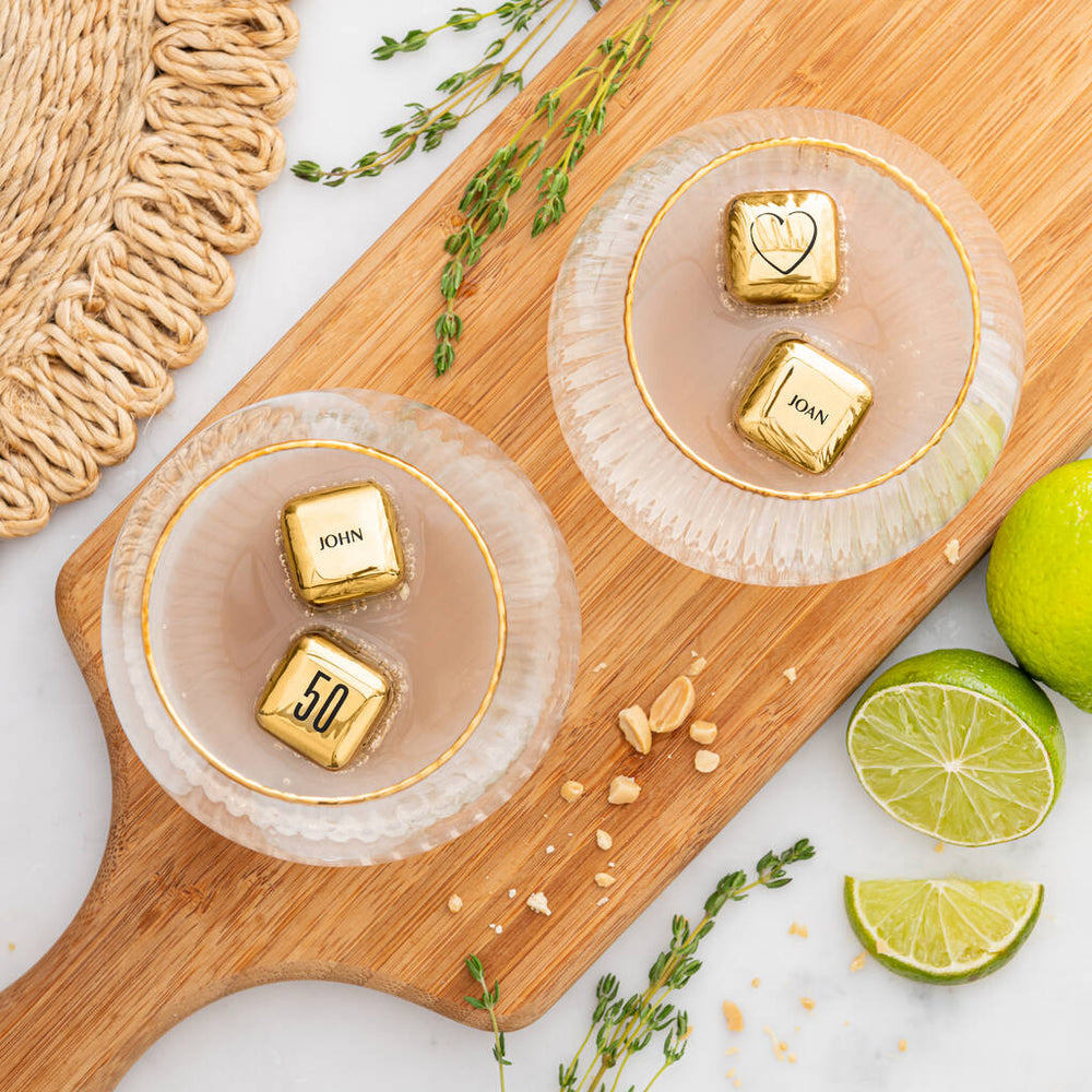 
                  
                    Set of four personalised gold finish stainless steel ice cubes. Add initials, names or dates to create a thoughtful golden wedding anniversary gift.
                  
                