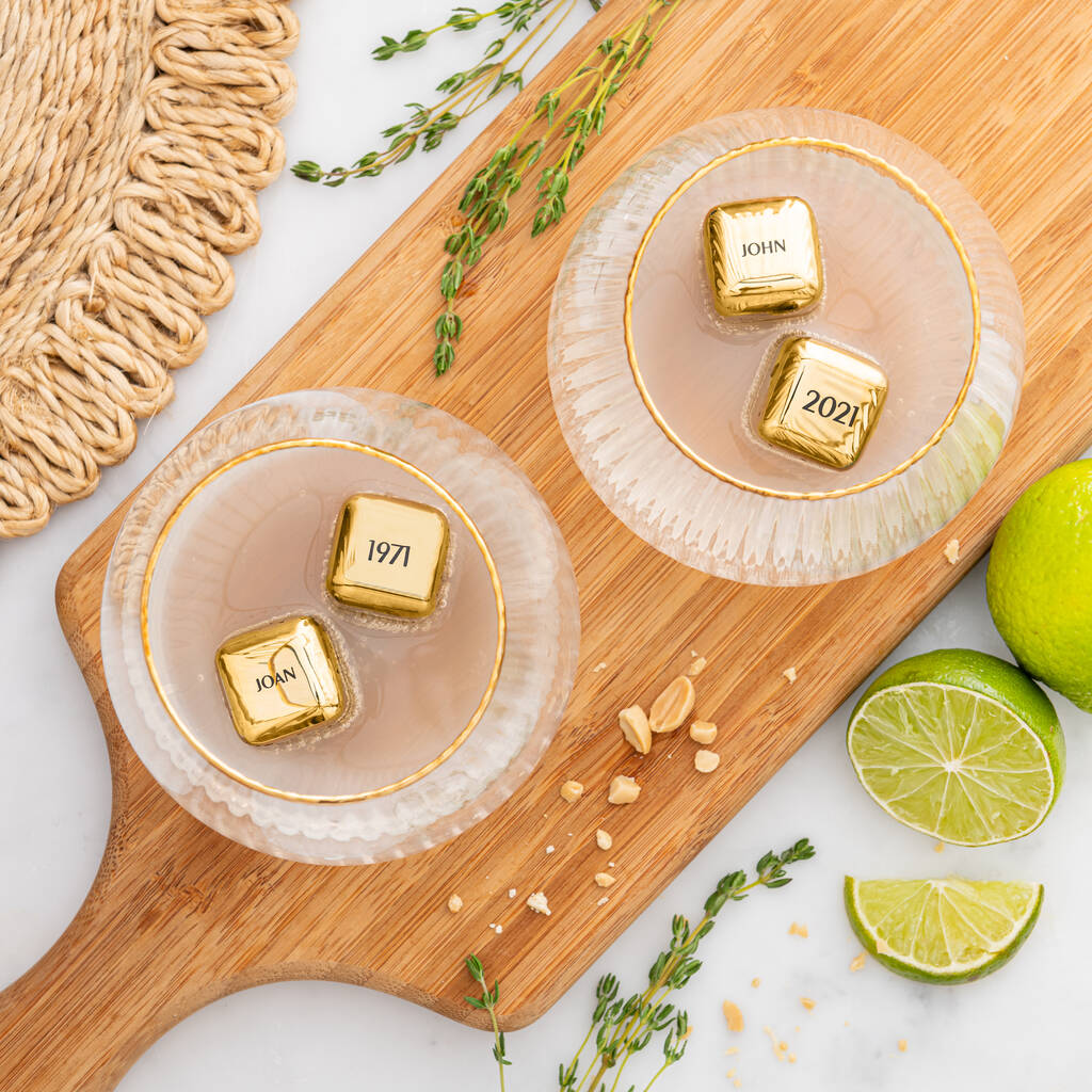 
                  
                    Set of four personalised gold finish stainless steel ice cubes. Add initials, names or dates to create a thoughtful golden wedding anniversary gift.
                  
                