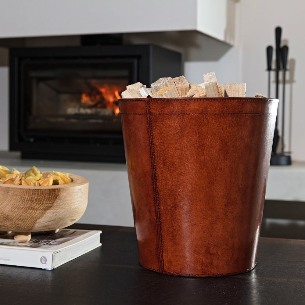 Leather kindling bin with removable metal liner for use in the home or office. Makes a practical gift for dad or a new home gift for special friends.