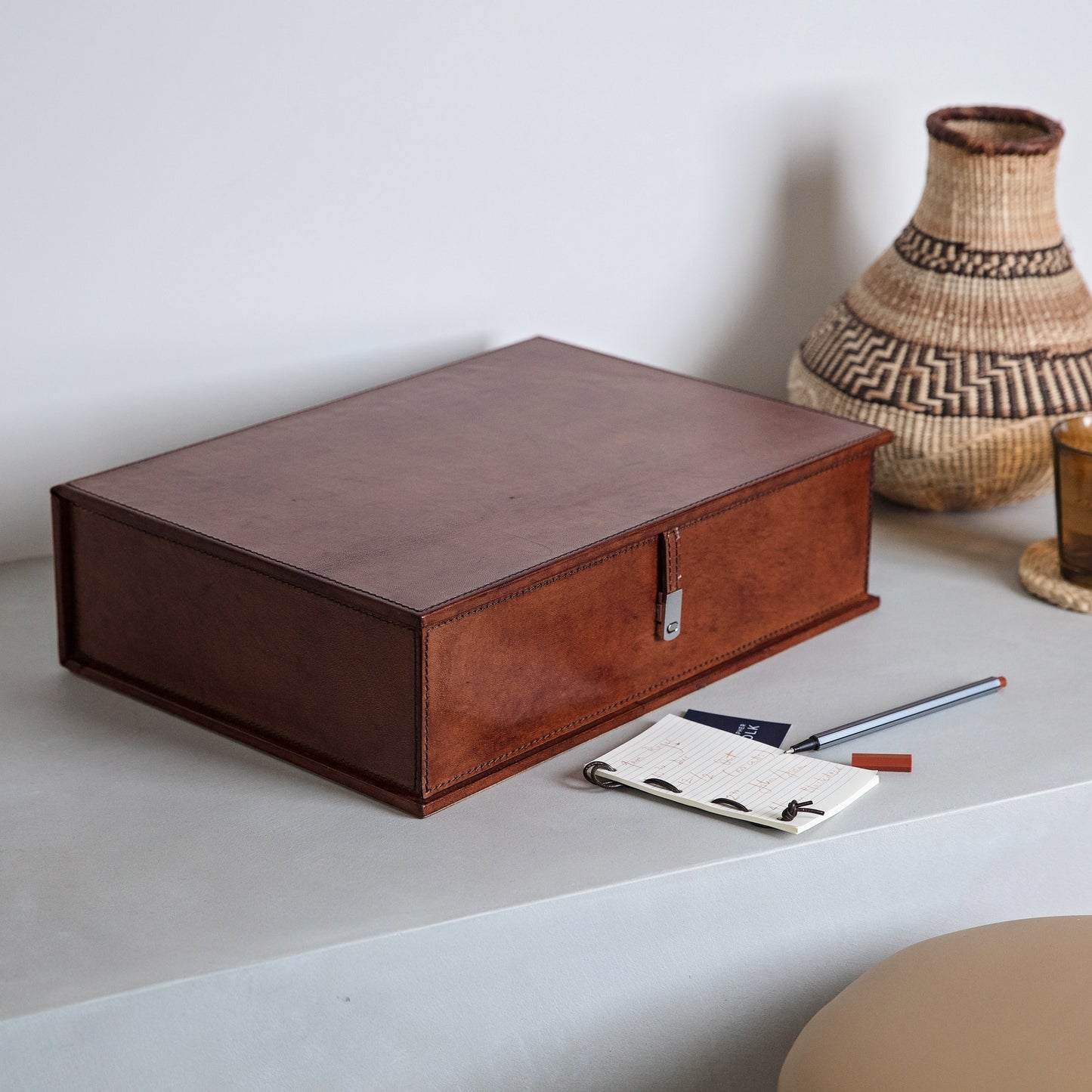 Leather box file in tan with suede interior and chrome clasp. Perfect for storing important documents or as a memory box for someone special. Part of a collection of stylish desk and home accessories, that make thoughtful gifts for him and her.