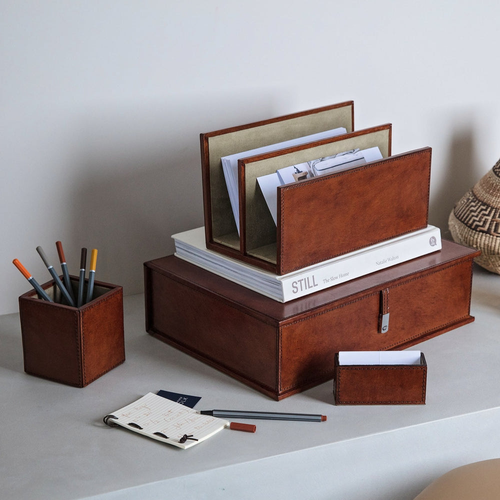 A practical and stylish leather desk set combining a box file, letter rack, pen pot and business card holder to keep desk spaces clutter free. Personalise for a thoughtful and unique gift for the home office or to celebrate a new job.