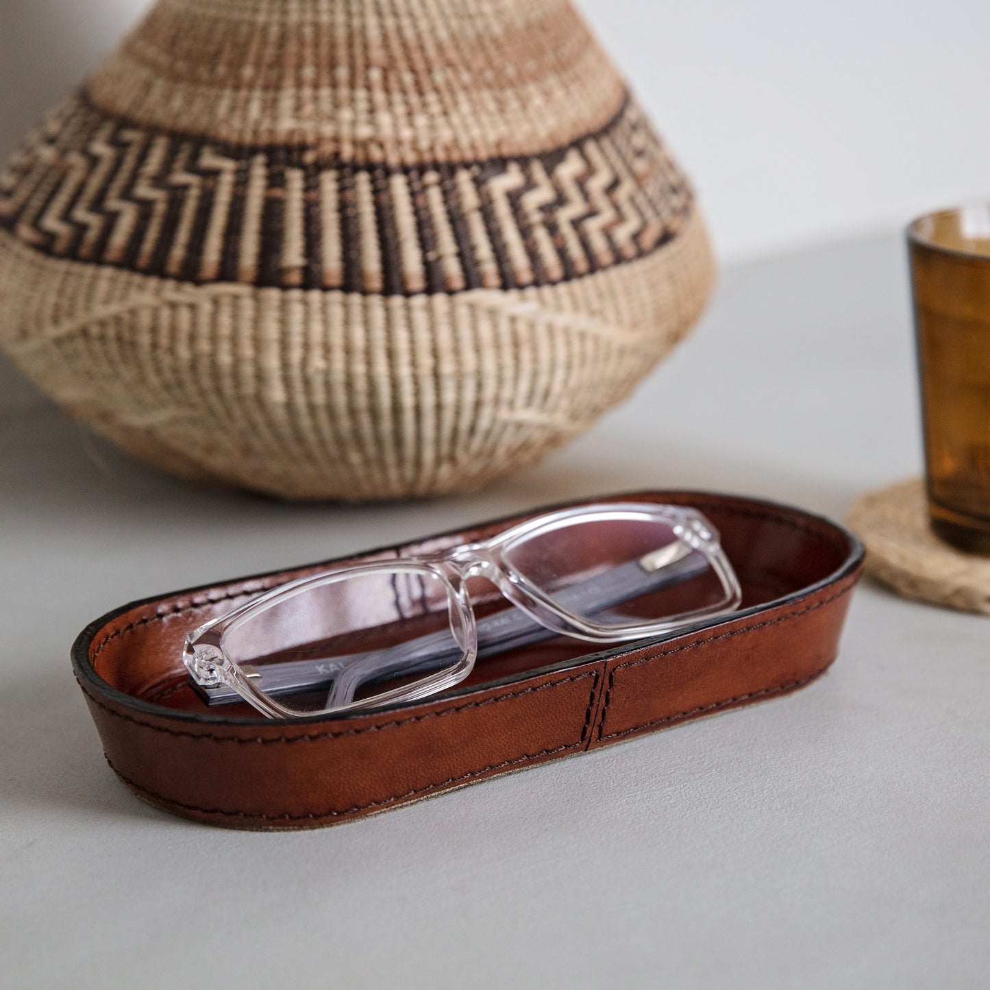 Soft, oval leather tray for glasses to use on the desk or bedside table. Handmade in tan leather and part of a collection of stylish desk and home accessories, that make thoughtful gifts for Father’s Day or a new home.