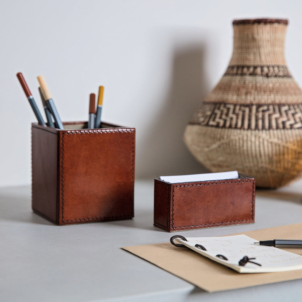 Leather pen pot and business card holder desk accessory set in tan leather. Personalise both to create a thoughtful and unique gift to celebrate a 3rd wedding anniversary or a new job.