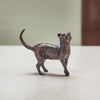 Miniature bronze figurine of a cat walking with its head held high. A perfect bronze anniversary gift.