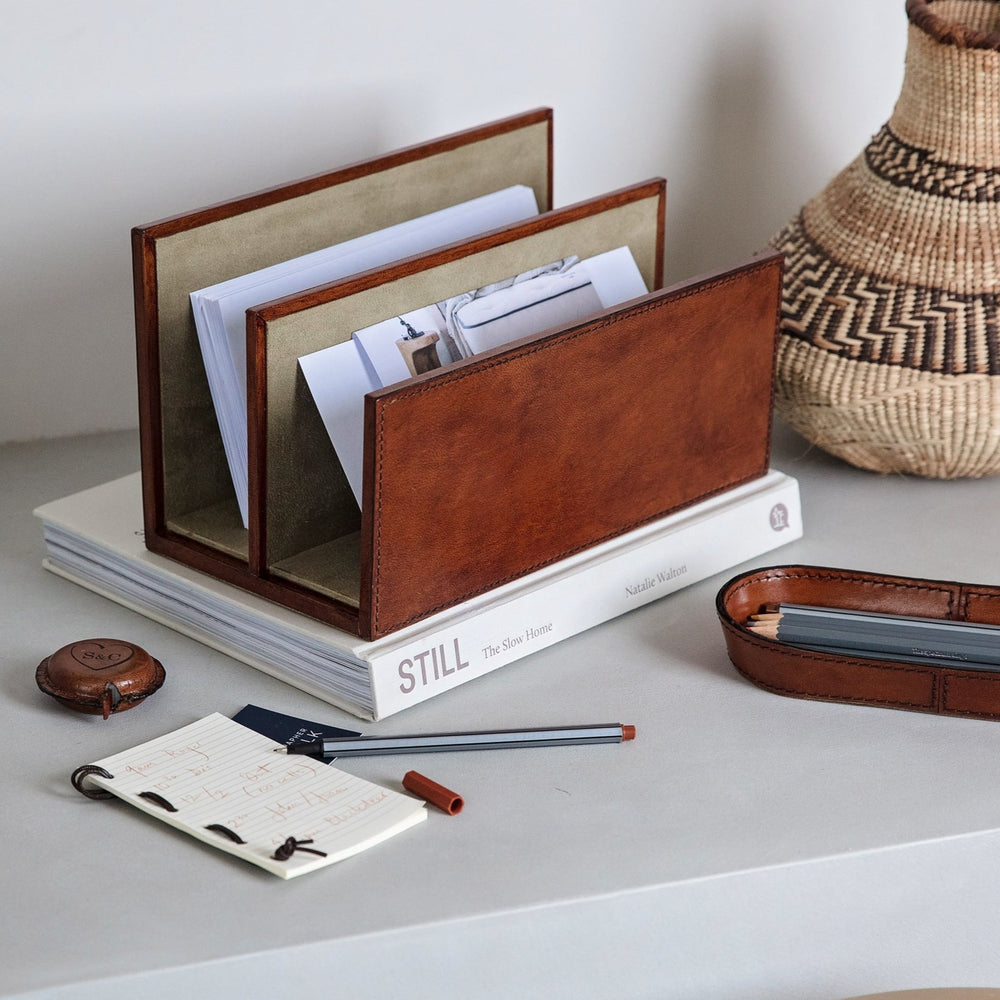 
                  
                    A thoughtful and unique gift for a new home or to celebrate retirement, this trio of letter rack, pen tray and personalised leather tape measure is classic, stylish and practical.  
                  
                