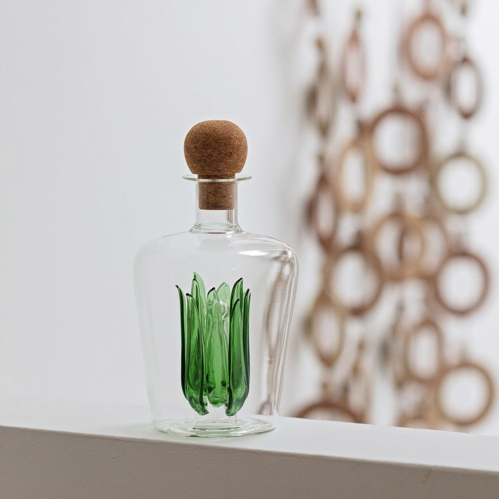 
                  
                    Unique glass tequila decanter with green glass agave leaves inside and a round cork stopper. Ideal as a gift for a housewarming, wedding or special birthday.
                  
                